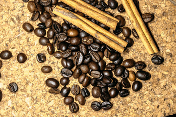 Fresh black coffe beans on cork table