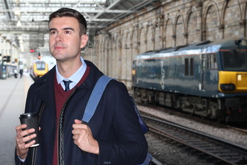 Businessman walking in retro train station 