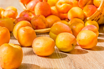 Ripe apricots on a wooden table, close-up