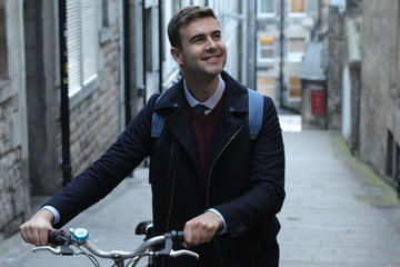 Classic looking man carrying bicycle upstairs