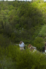 small cozy cottage-castle stands in the woods in the village