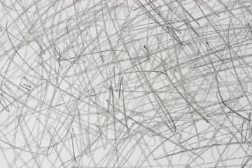 gray crayon doodles on paper background texture