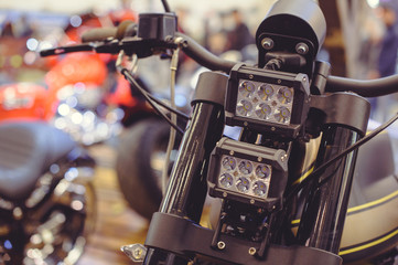 Fototapeta na wymiar modern LED motorcycle headlight, close-up on the front