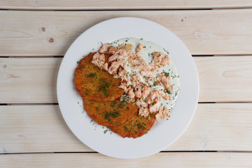 Potato pancakes with chopped salmon. Top view.