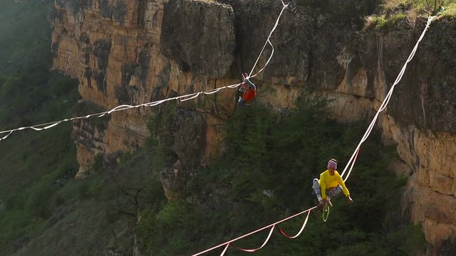 Funambulist in the mountains enjoying nature. slow motion