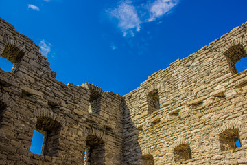 old ruins wall and blue sky background with empty space for copy or text