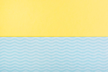 minimal summer yellow blue background symbolizing the sea with waves and sand.