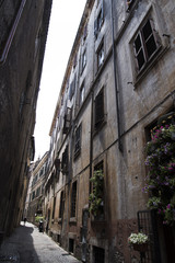 A very narrow street in Rome, the sky is hard to see