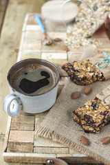 Homemade oatmeal raisin cookies with coffee on wooden background