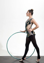 Sport success and health. Fitness and dieting of girl gymnast. Woman with gymnastic ring. Workout sports activities in gym of flexible girl. Woman train acrobatics with hula hoop in sportswear