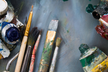 Bright oil paints in a tube on a dirty palette. Paints in use.