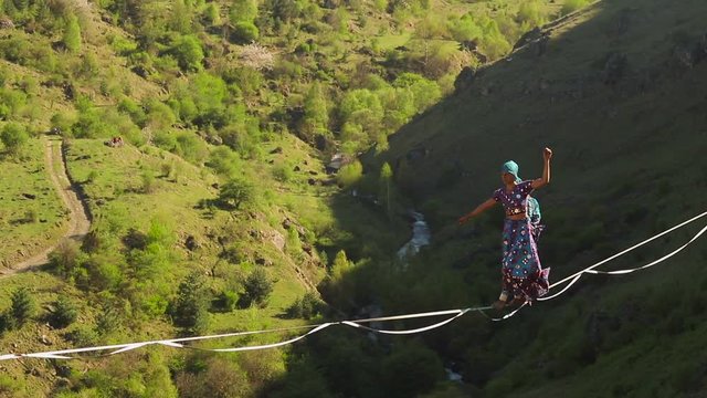 Funambulist in the mountains enjoying nature. slow motion