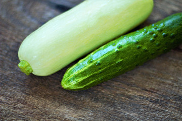 Still life of fresh vegetables. Zucchini (Cucurbita pepo subsp. Pepo) and cucumber (Cucumis sativus). Add to your diet and get vitamins PP, C, B, potassium, magnesium, macro and trace elements.