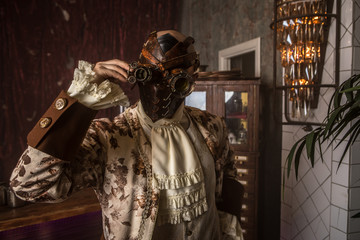 Actor in steam punk masks and antique costumes indoor.
