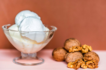 Vanilla ice cream in bowl and walnuts