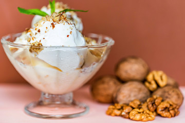 Vanilla ice cream in bowl and walnuts