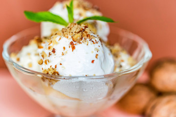 Vanilla ice cream in bowl and walnuts