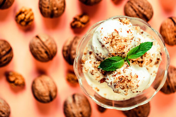 Vanilla ice cream in bowl and walnuts
