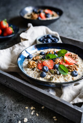 Bircher muesli with strawberries, blueberries, chia seeds, walnuts, sunflower seeds and pumpkin seeds