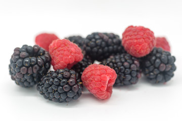 Blackberries and Raspberries against a white background