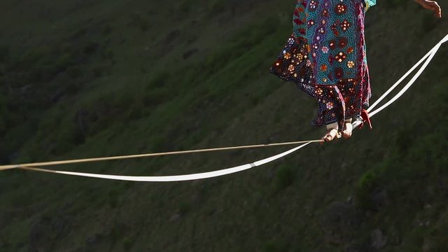 Funambulist in the mountains enjoying nature. slow motion