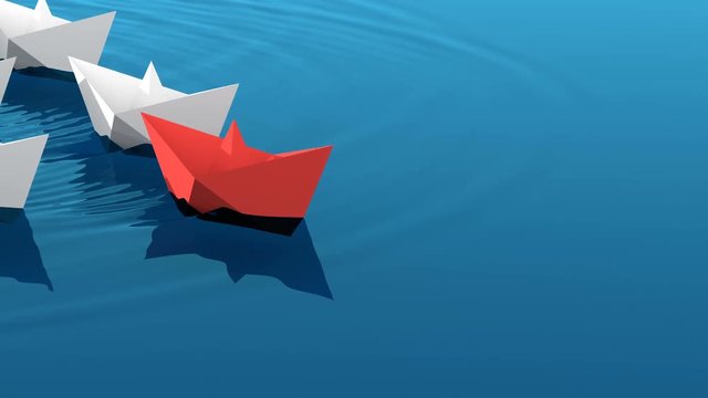 Leadership concept, red leader boat with white paper boats floating in the blue waves of the sea