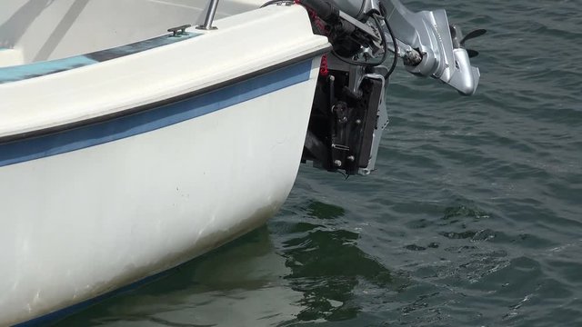 Closeup of a boat with an outboard motor in the harbor