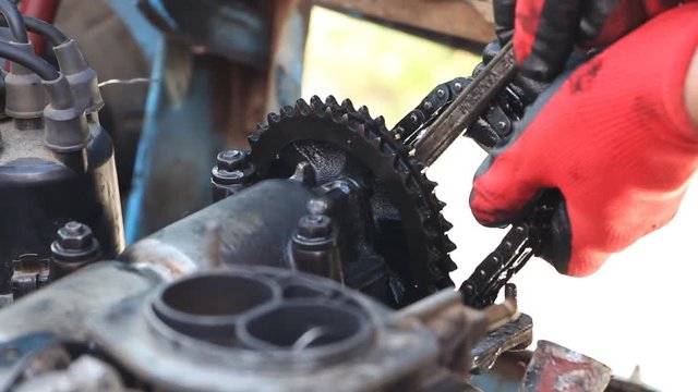 Car repair. A man removes a car engine circuit