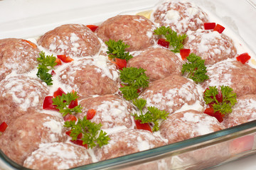 Meat minced red with aromatic seasonings on a white background.