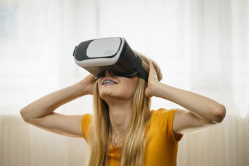 Girl wearing virtual reality goggles.