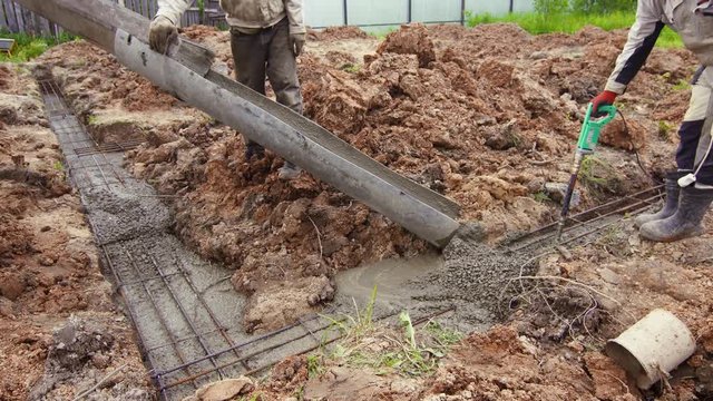 workers poured cement Foundation Building a cottage