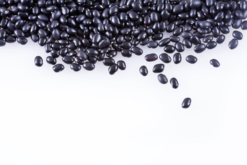 Raw black beans on white background
