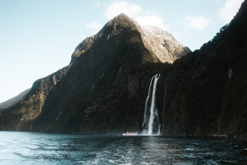 New Zealand: photo of beautiful waterfall in rocky mountains 