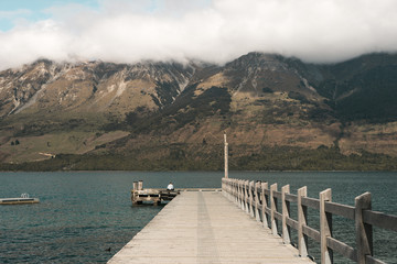 New Zealand, Glenorchy: photo of beautiful rocky mountains with blue lake and wooden bridge