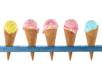 ice cream in waffle cones in rustic wood holder isolated on white background
