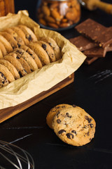 Freshly baked chocolate almond chip cookies in wooden box