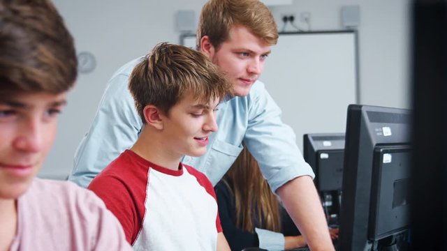Teenage Students Studying In IT Class With Teacher