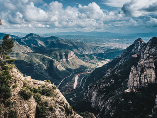 Aerial view of Montserrat mountains and river in a beautiful sunny summer day. Blue sky with clouds. Catalonia (near Barcelona), Spain