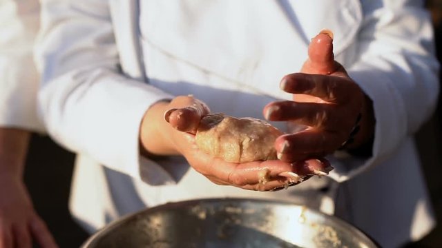 A woman makes a cutlet with fresh ground meat in a home kitchen, slow motion