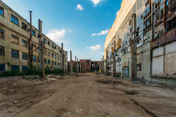 Territory of abandoned industrial area waiting for demolition. Broken and burnt buildings. Former Voronezh excavator factory