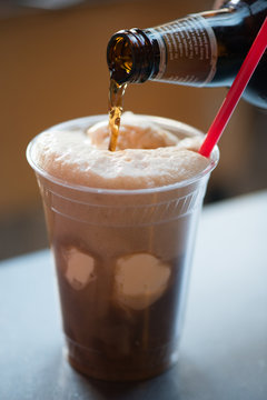 Root beer pouring into a root beer float