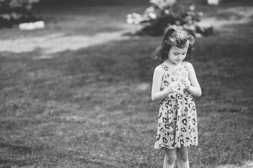 Young girl looking down at her glasses