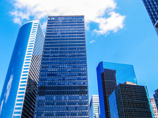 Vertical of modern shiny blue facade of high rise buildings in Manhattan, New York city, USA.