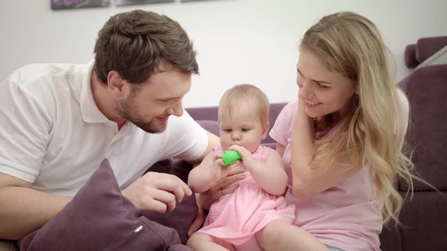 Happy family playing together. Mother and father play with child at home. Togetherness love concept. Joyful family with baby embrace. Enjoy together time. Sweet parenting