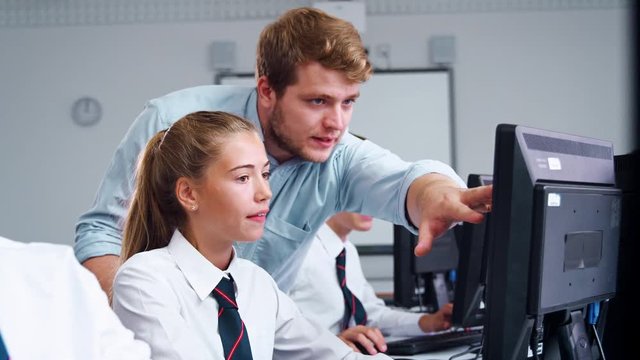 Teenage Students Wearing Uniform Studying In IT Class