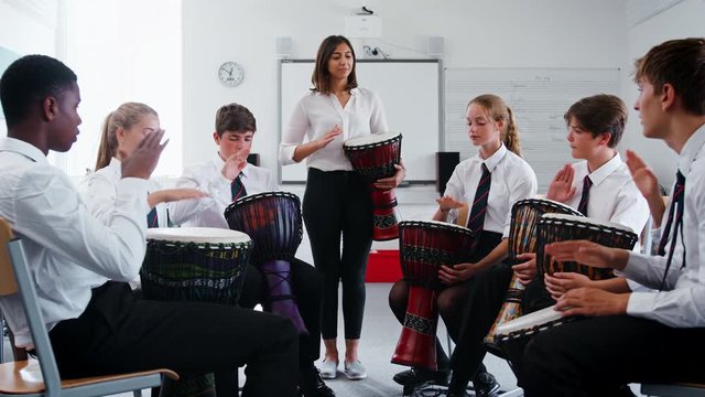 Teenage Students Studying Percussion In Music Class 