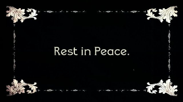A re-created film frame from the silent movies era, showing intertitle text messages: Rest in Peace.
