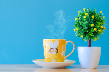 tree plastic and tea cup on blue background,select focus