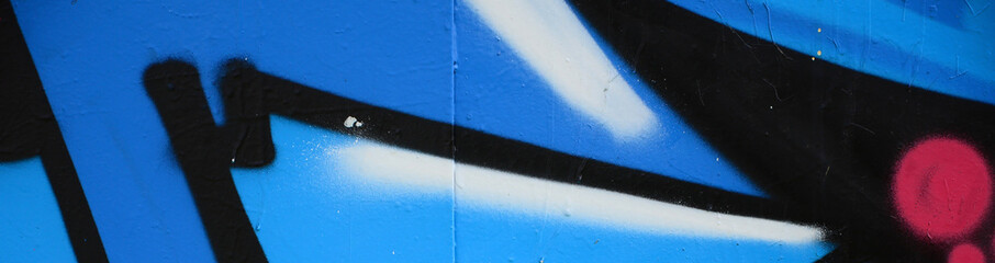 Street art. Abstract background image of a fragment of a colored graffiti painting in blue tones