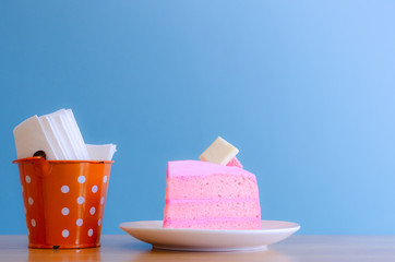 pink cake and  Tissue in tank on blue background,break time,select focus.